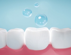 A 3D rendering of drops of fluoride covering teeth