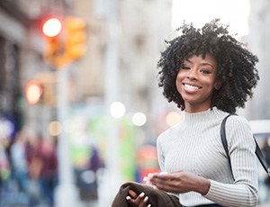 woman smiling while enjoying a day on the town