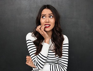 woman nervously biting her nails