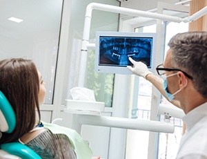 dentist showing a patient their X-rays