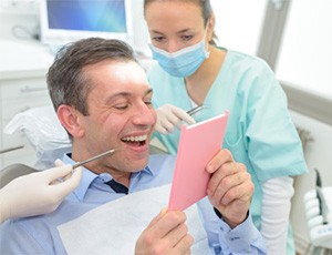 patient admiring his smile in a mirror