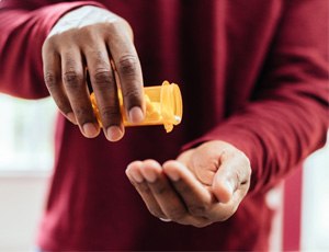 a person taking medication pills in Harrisburg