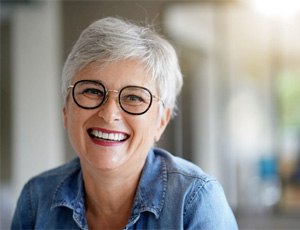 a woman smiling with a dental implant in Harrisburg