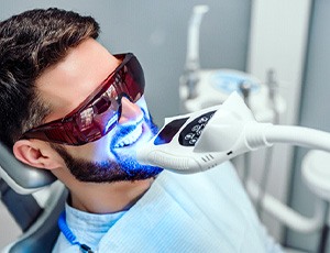 A closeup of a man receiving teeth whitening