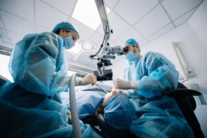 Dentists performing surgery on patient.